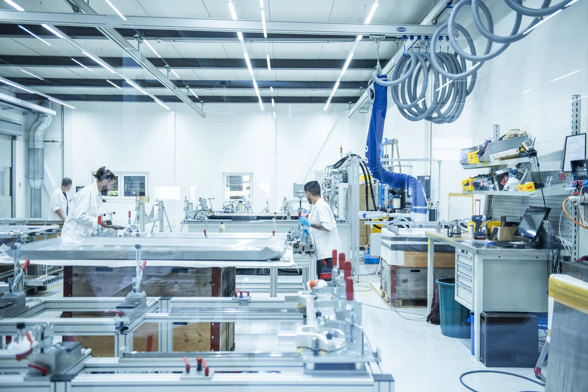 在一个环境受控的隔离装配室内有3名工人。