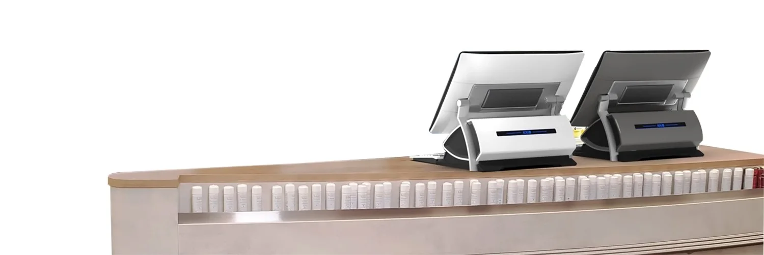 两台JDM销售点系统用于药房市场，位于销售柜台上，从背面查看。